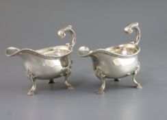 A pair of early George III silver sauceboats with flying scroll handles, maker, F.M, (unidentified