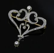 A French Belle Epoque 18ct gold and diamond set openwork scroll drop pendant brooch, 38mm.