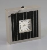 A Cartier black enamel and steel cased timepiece, with silvered Roman dial, number 145450GD/2747,