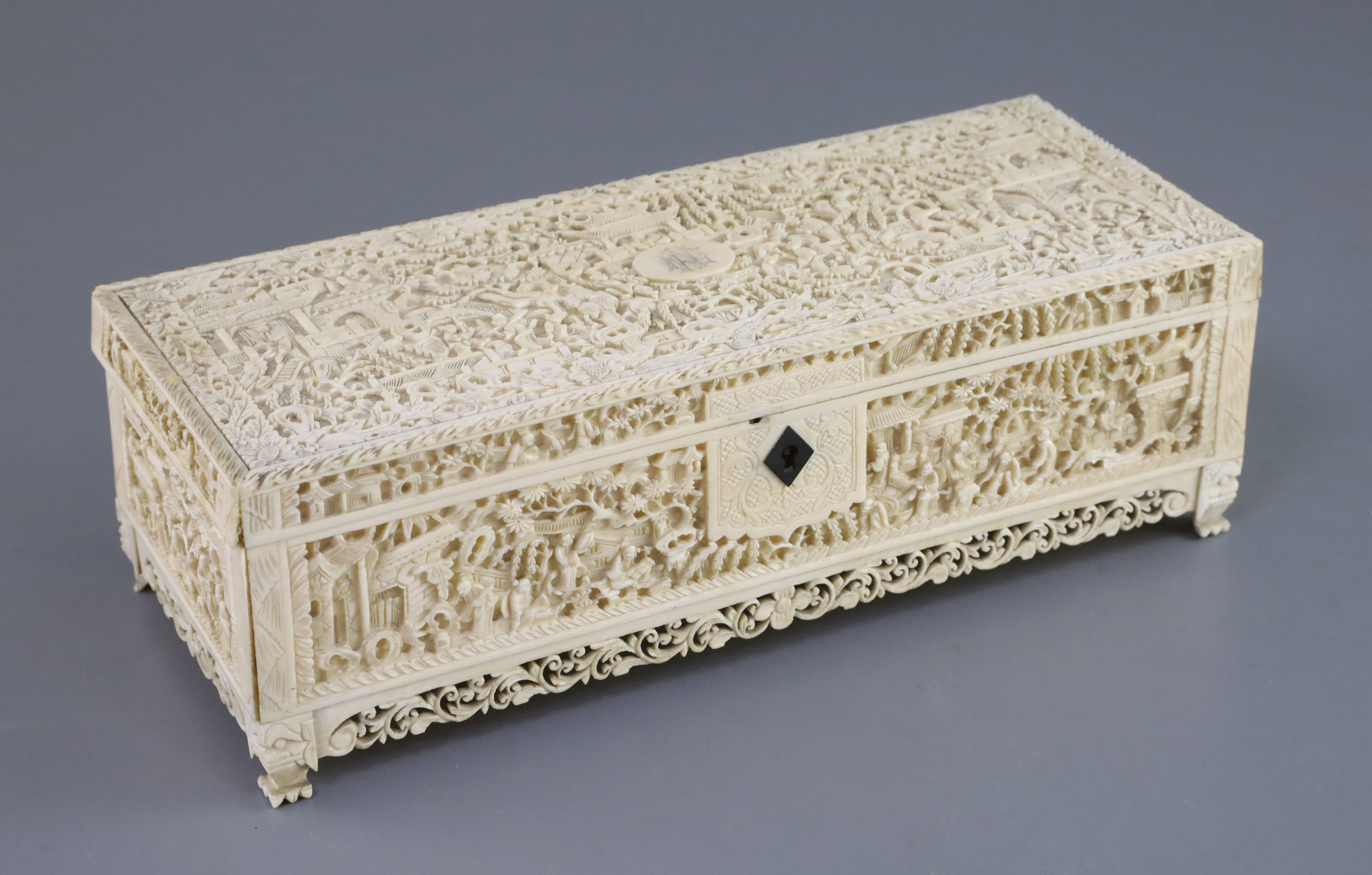 A Chinese export ivory casket, 19th century, carved in high relief with figures amid paviloins and
