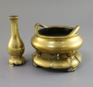 A Chinese polished bronze censer with stand and a similar bottle vase, 17th/18th century, the tripod