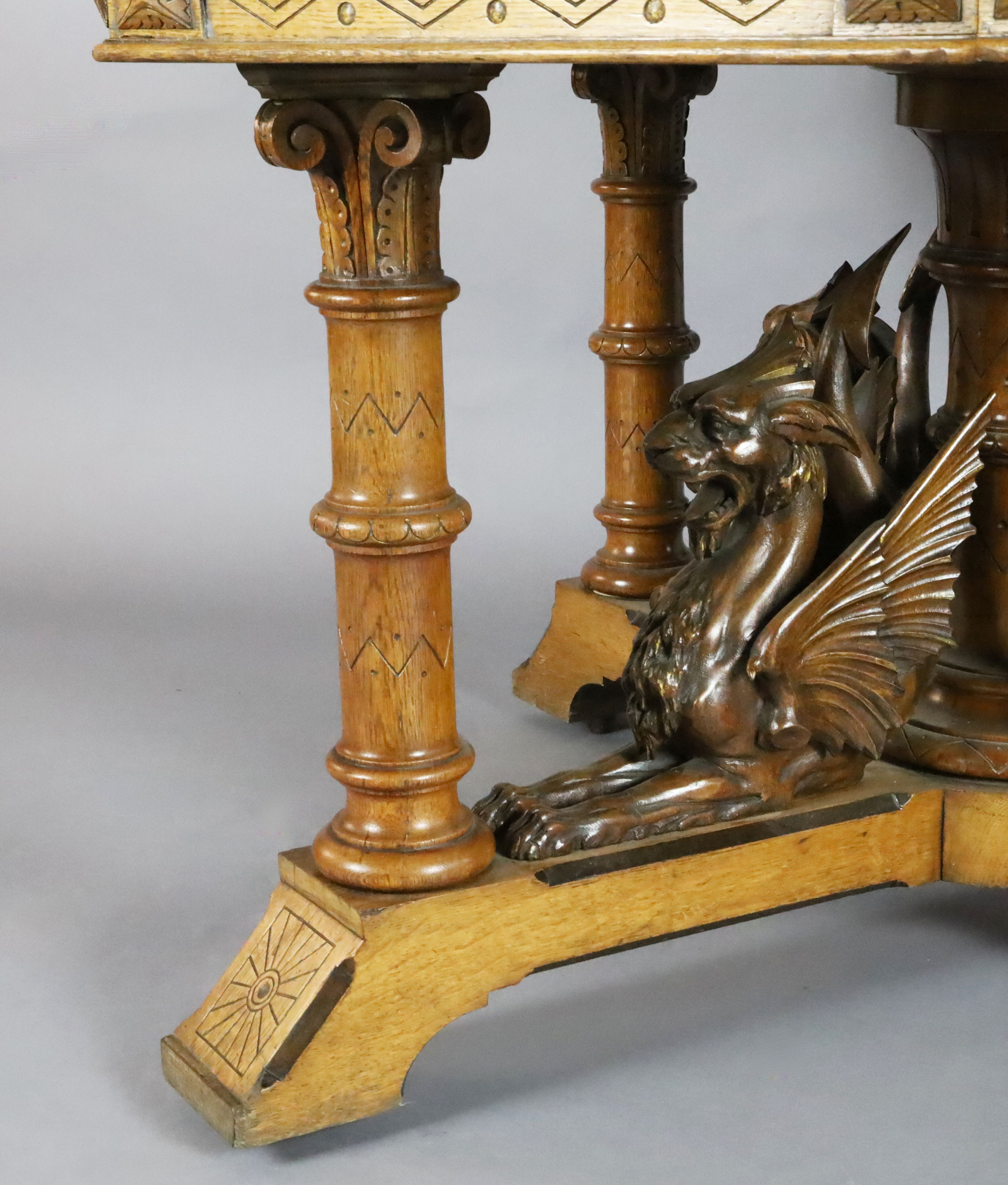 A Victorian Gothic revival golden oak centre table, with octagonal top, the underframe carved with - Image 4 of 4