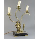 A gilt bronze and brass three light table lamp, modelled with a Chinese figure and parrot