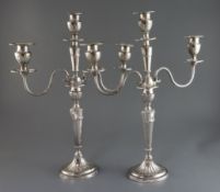 A pair of Edwardian silver two branch three light candelabra by Mappin & Webb, decorated with