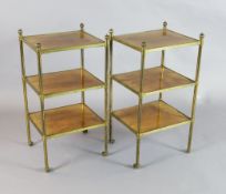 A pair of early 20th century tubular brass and walnut three tier etageres, with fluted ball