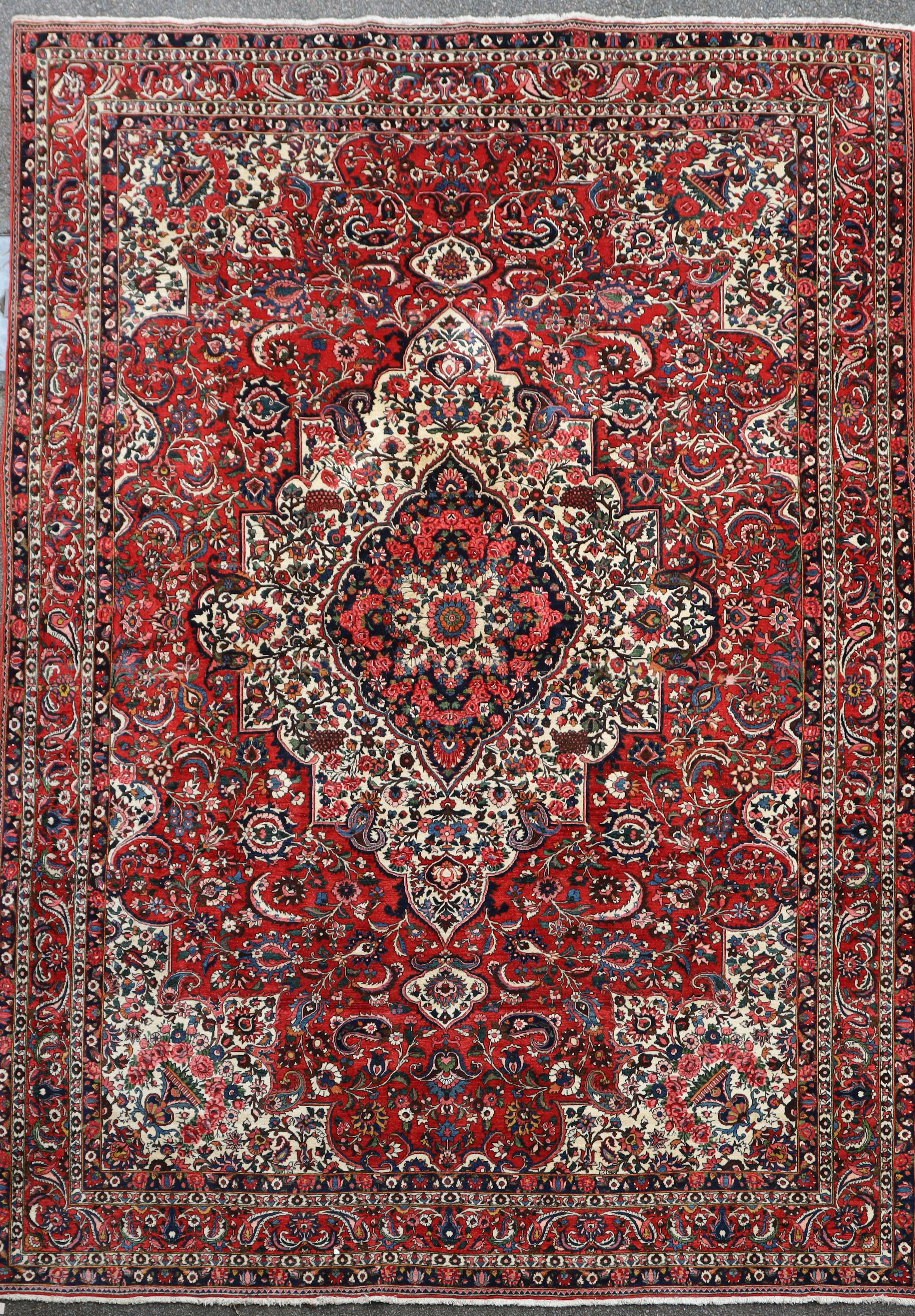 A Bakhtiar Chaleshotor red ground carpet, with central medallion in a field of scrolling foliage and