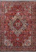 A Bakhtiar Chaleshotor red ground carpet, with central medallion in a field of scrolling foliage and