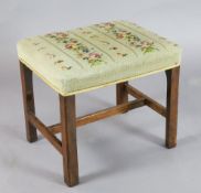 A George III mahogany stool, with later needlework seat, on chamfered legs, W.1ft 8.5in. D.1ft