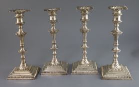 A set of four early George III silver candlesticks by William Cafe, with turned knopped stems and
