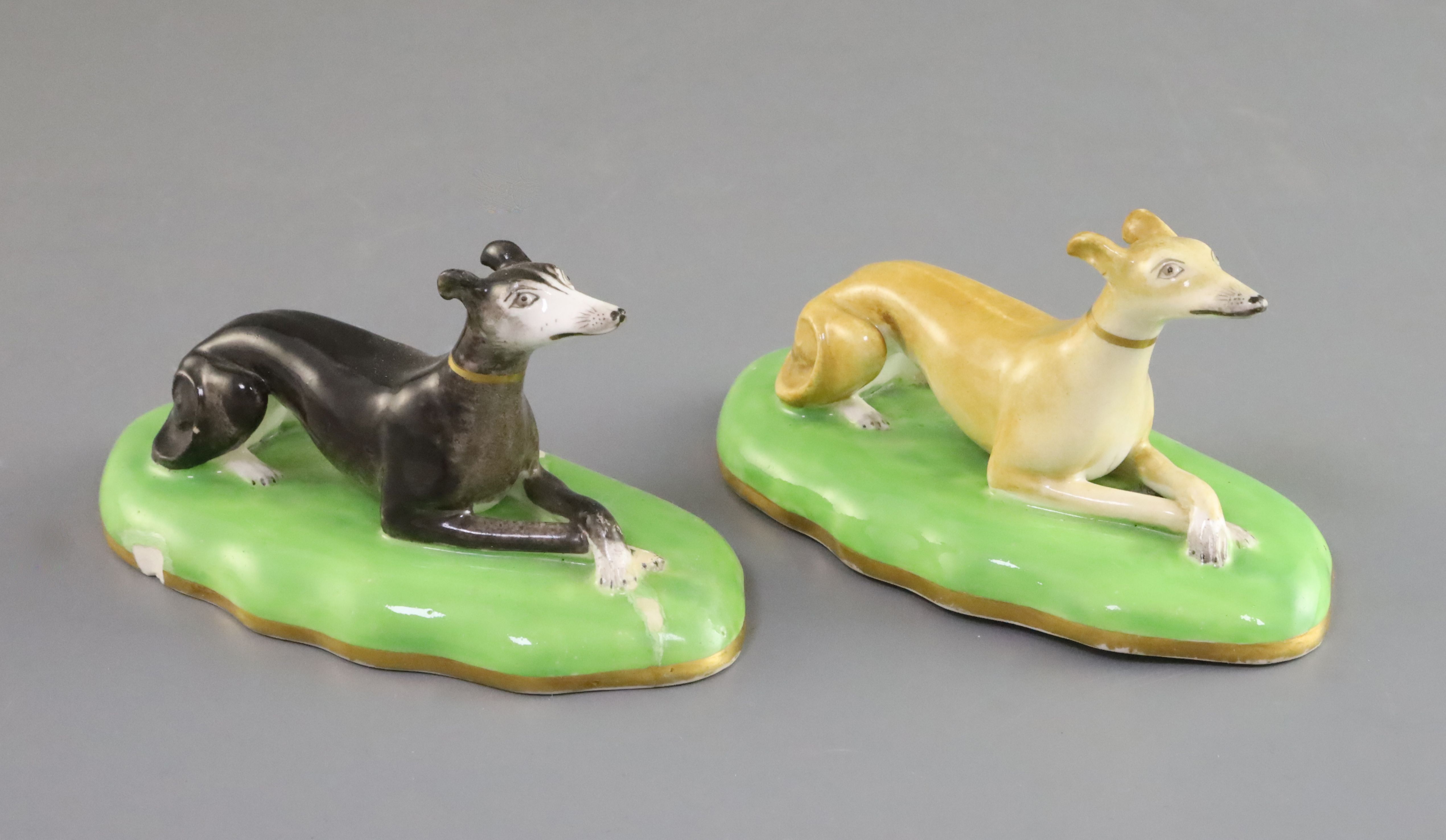 A pair of Copeland & Garrett porcelain figures of greyhounds, c.1833-47, each recumbent on a shallow