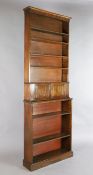 A Victorian slender mahogany open bookcase, with six adjustable shelves and cupboard compartment,