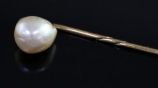 An oval button shaped natural saltwater pearl set stick pin, with Gem & Pearl Laboratory report date