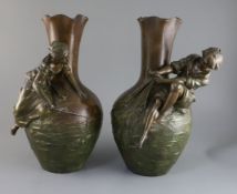 After Auguste Moreau. A pair of bronzed pewter figural vases, modelled in relief with a boy and girl