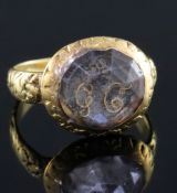 A late 17th century gold and Stuart crystal memento mori ring, with carved shank and facetted rock