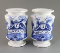 A pair of Dutch delft blue and white drug jars, c.1800, painted with stags and titled "E/DIASCORD: