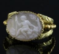 A 19th century two colour gold and oval cameo set ring, the cameo carved with a seated figure with