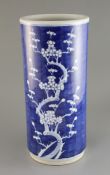 A Chinese blue and white stick stand, c.1900, painted with prunus, unglazed base, H. 47cm
