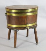 A George III brass banded mahogany oval wine cooler, with original lead lining and brass tap, on