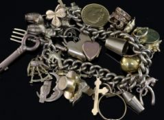 A 9ct gold curb link charm bracelet, hung with twenty nine assorted charms, including a 1911 half