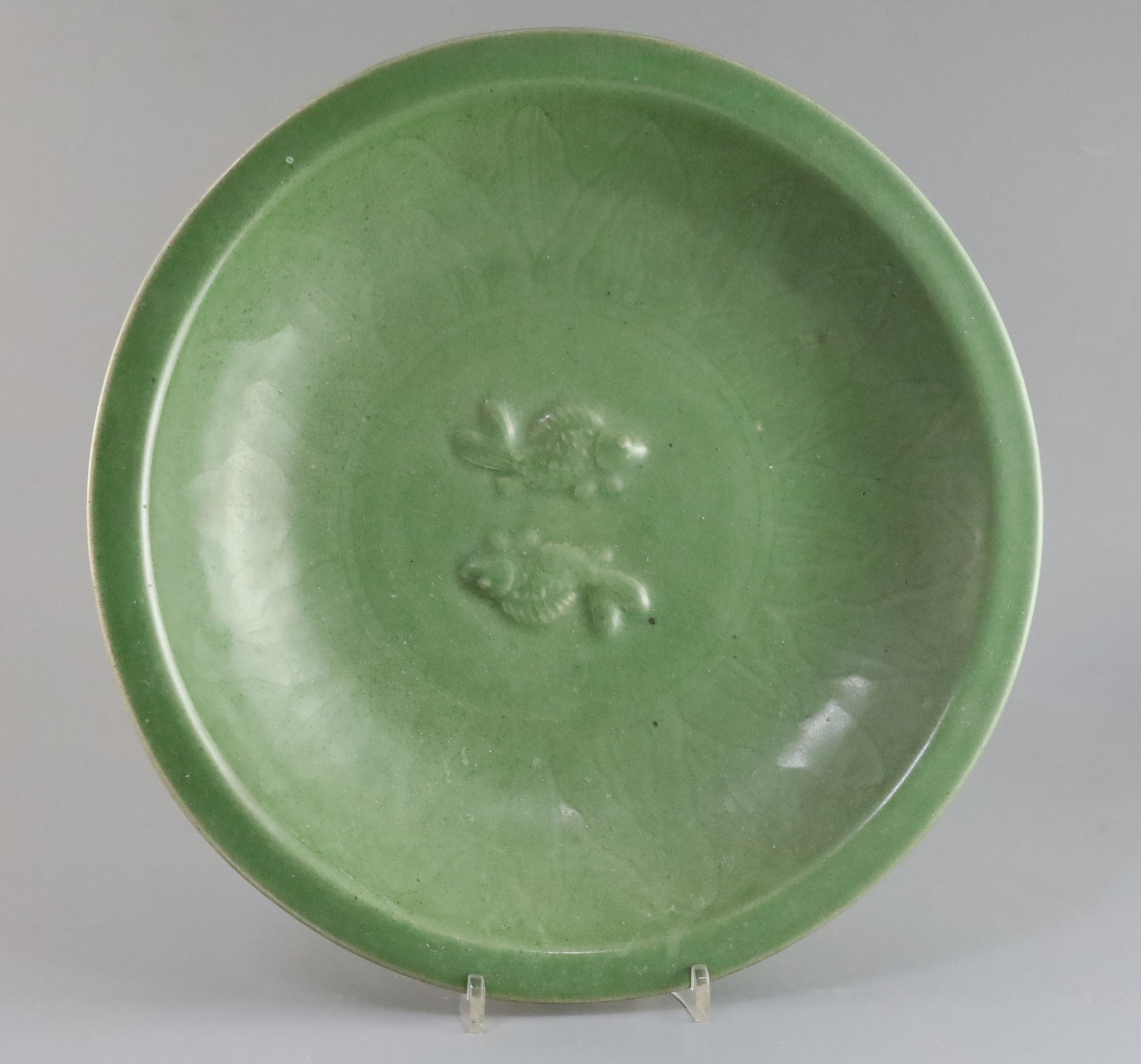 A Chinese celadon glazed 'twin fish' dish, Qing dynasty, the centre moulded with twin carp within an