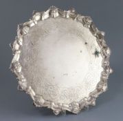 A George III silver salver, of shaped circular form, with shell and scroll border and later?