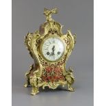 An early 20th century French ormolu and red boulle mantel timepiece, with enamelled Roman dial and