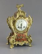 An early 20th century French ormolu and red boulle mantel timepiece, with enamelled Roman dial and