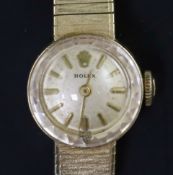 A lady's 14k gold Rolex manual wind wrist watch, with baton numerals, on 14k gold integral