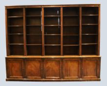 An early Victorian mahogany library bookcase, with five rows of adjustable open shelves over base