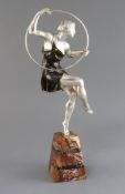 Attributed to G. Limousin. A silvered and bronzed metal figure of a hoop dancer, on tapered marble