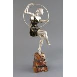 Attributed to G. Limousin. A silvered and bronzed metal figure of a hoop dancer, on tapered marble