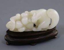 A Chinese white jade carving of a squirrel, grapes and lotus leaf, 18th/19th century, L. 6.4cm, wood