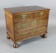 A William III oyster olivewood chest of drawers, c.1700, the top with boxwood tracery, two short and