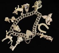 A 1960's 9ct gold charm bracelet, hung with ten assorted charms, gross 57 grams.