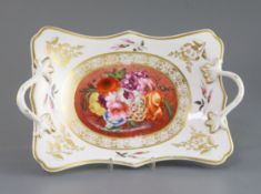 An early 19th century English porcelain two handled dish, decorated with a painted panel of flowers,