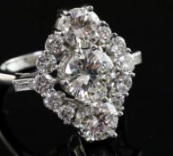 An attractive 18ct white gold and diamond cluster elliptical shaped ring, with three central stones,