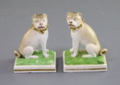 A pair of Derby porcelain figures of seated pug dogs, c.1830, modelled by Edward Keys, each seated