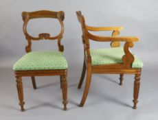 A set of nine William IV oak dining chairs, including two carvers, with scroll carved frames and