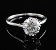 An 18ct gold and platinum set solitaire diamond ring, the round brilliant cut stone weighing