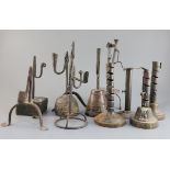 Eleven 17th century and later iron rushlight holders and candlesticks, largest 11.5in.