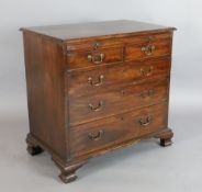 A George III mahogany chest, with brushing slide, two short and three graduated long drawers, on