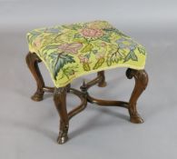 A late 17th century walnut stool, with upholstered seat, on acanthus carved cabriole legs with