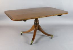 A Regency rosewood banded mahogany breakfast table, with tilt top on ring turned stem and ebony