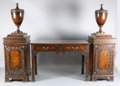 A late Victorian Chippendale style mahogany serving table, with pedestal cupboards, each mounted