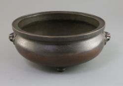 A Chinese large bronze tripod censer 17th/18th century, with a pair of lion mask handles, on three