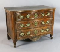 A Louis XVI fruitwood serpentine commode, with ormolu handles and locks and three long drawers, on