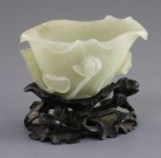 A Chinese pale celadon jade 'lotus' brushwasher, 18th/19th century, formed as a curled lotus leaf