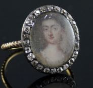 A George III gold and diamond set oval portrait ring, painted with the bust of a lady, size G/H.