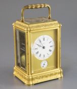 A late 19th century French ormolu quarter repeating carriage alarum clock, with floral scroll