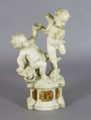 A 19th century Italian carved white marble group of two putti, standing upon a plinth with sienna